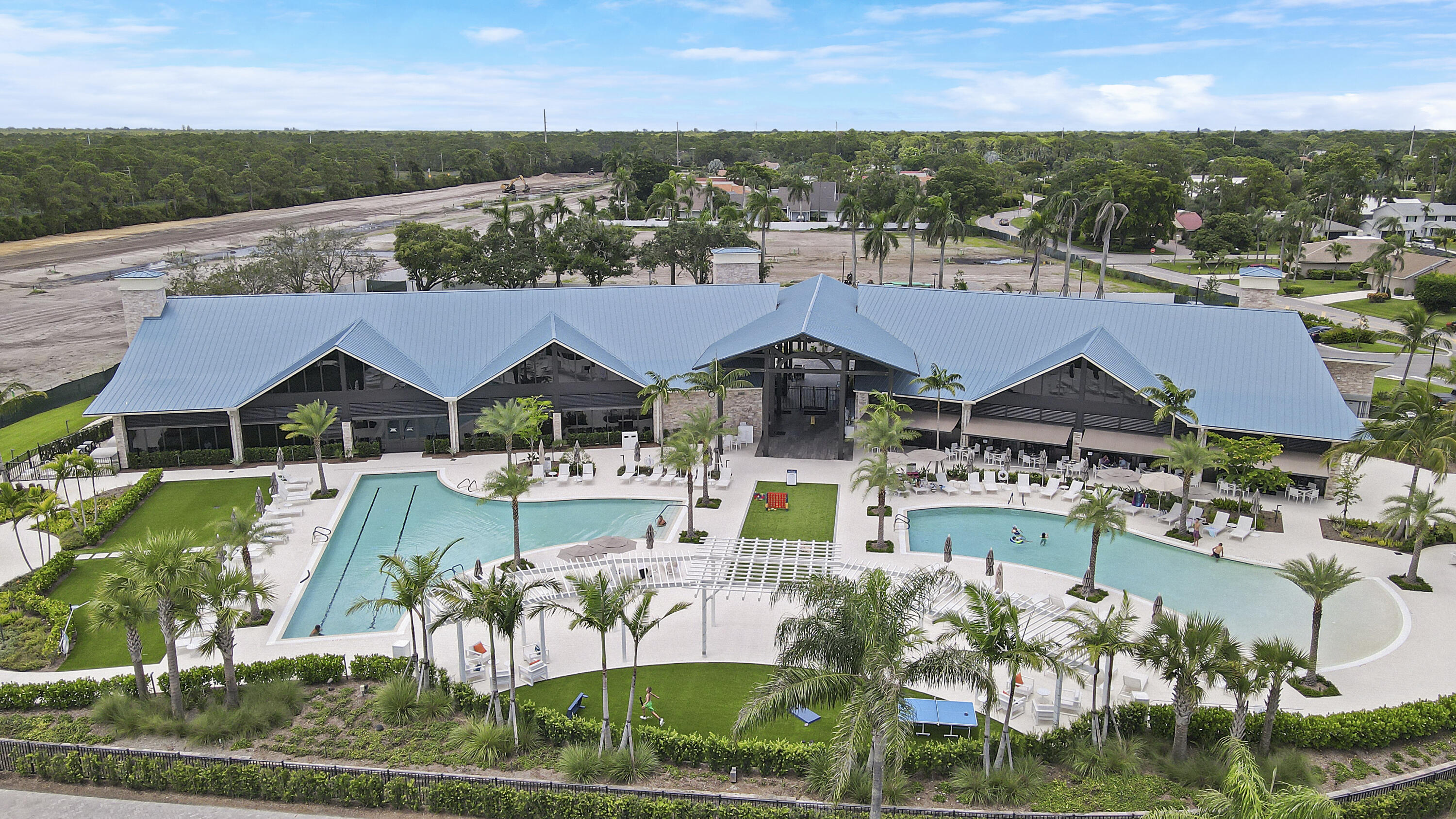 an aerial view of a house with swimming pool and outdoor seating