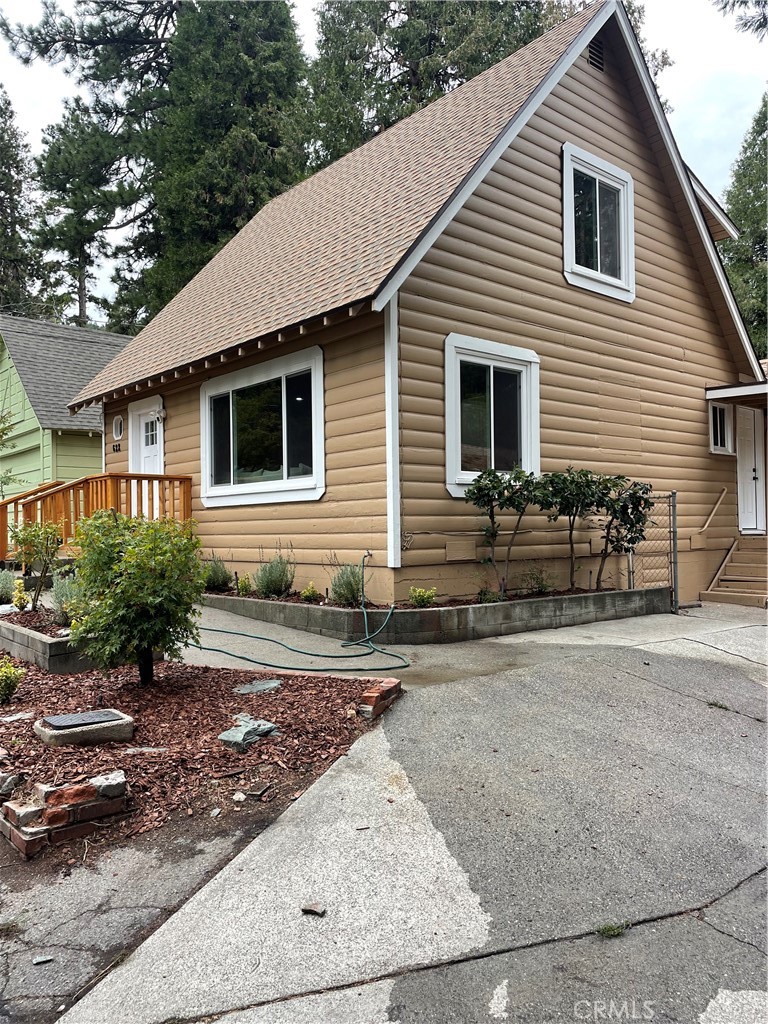 a backyard of a house with potted plants