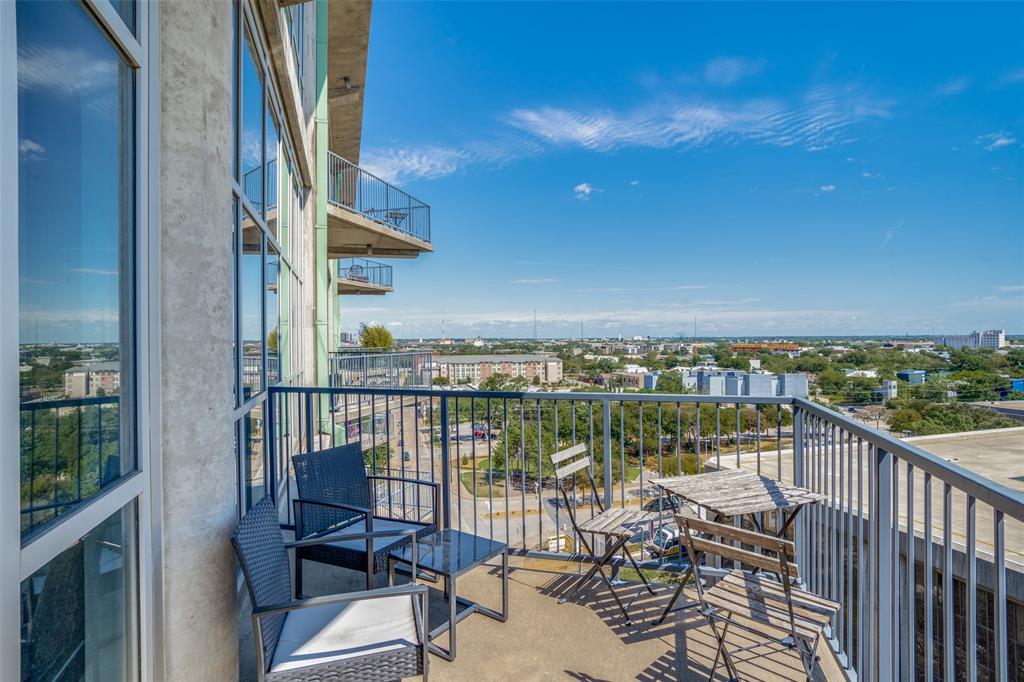 a view of a balcony with chairs and wooden floor