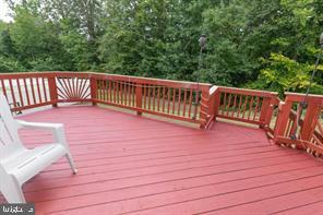 a view of balcony with wooden floor and fence