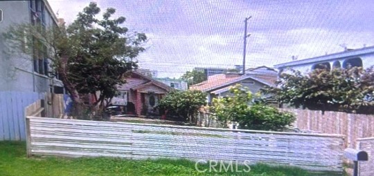 a view of a house with a yard and potted plants