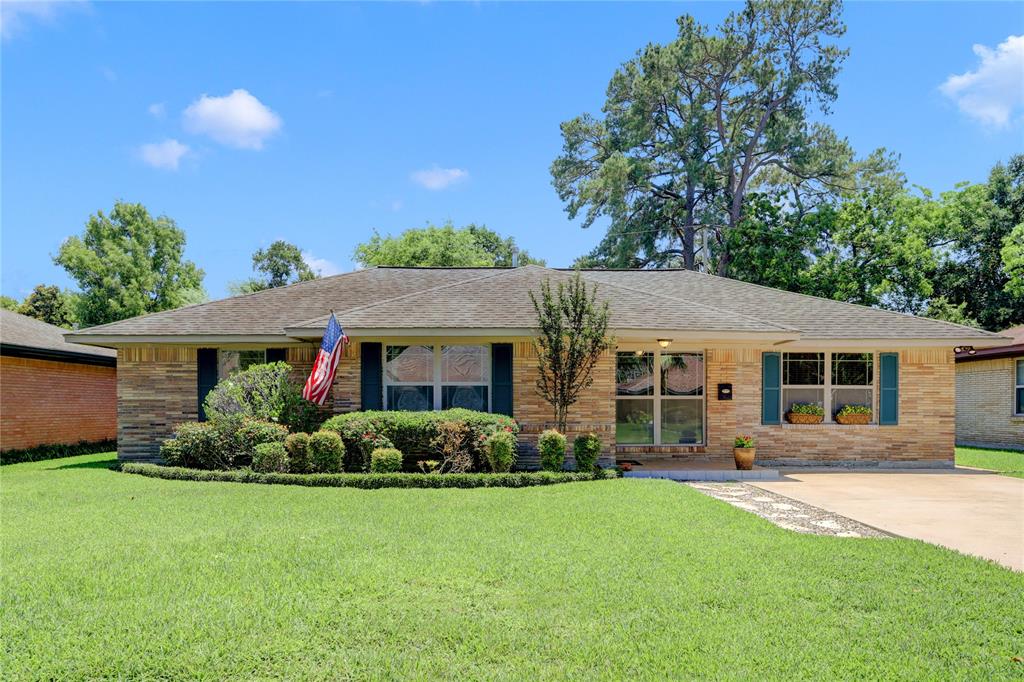 Front elevation is pristine with detailed landscaping, replaced double glazed windows, tiled, front porch, and located in popular Shepherd Forest