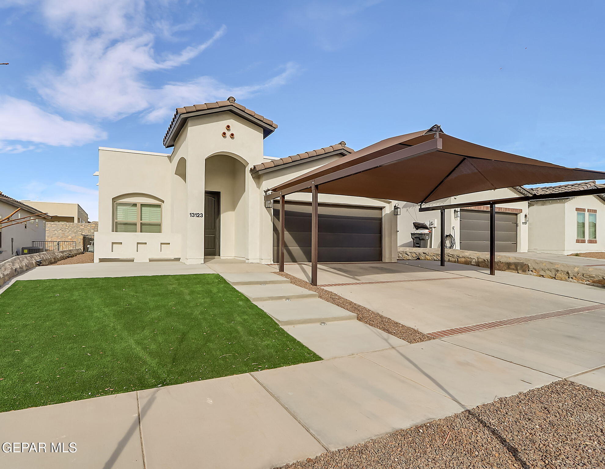 a front view of a house with a garden