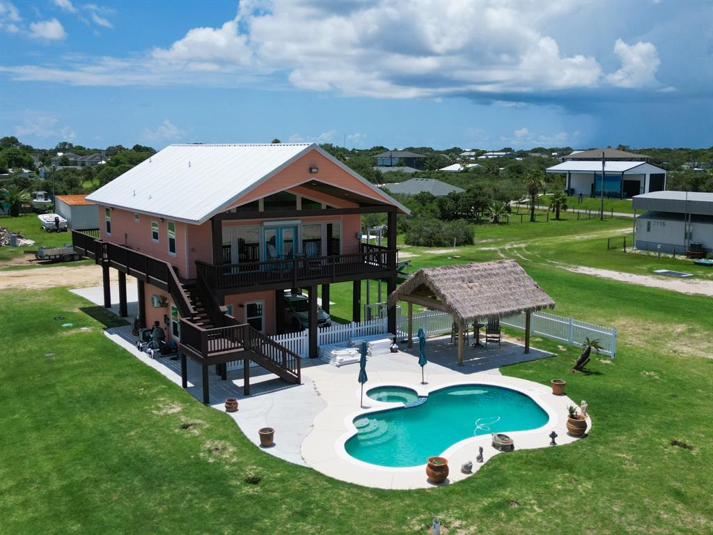 an aerial view of a house with swimming pool garden and patio