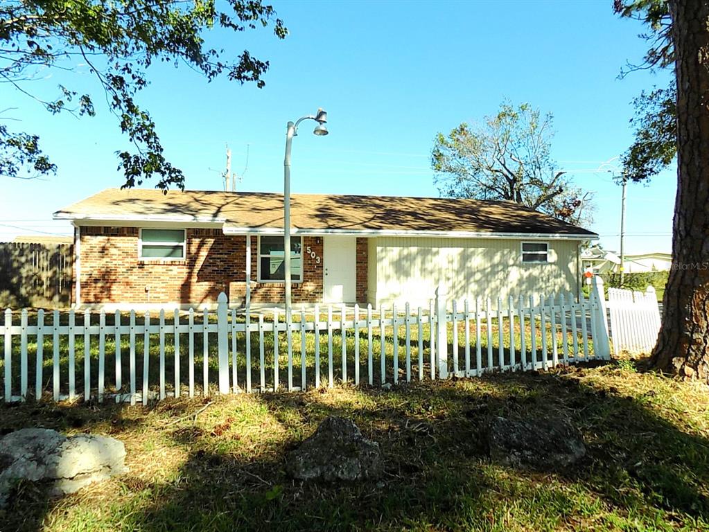 a view of a house with a small yard and plants