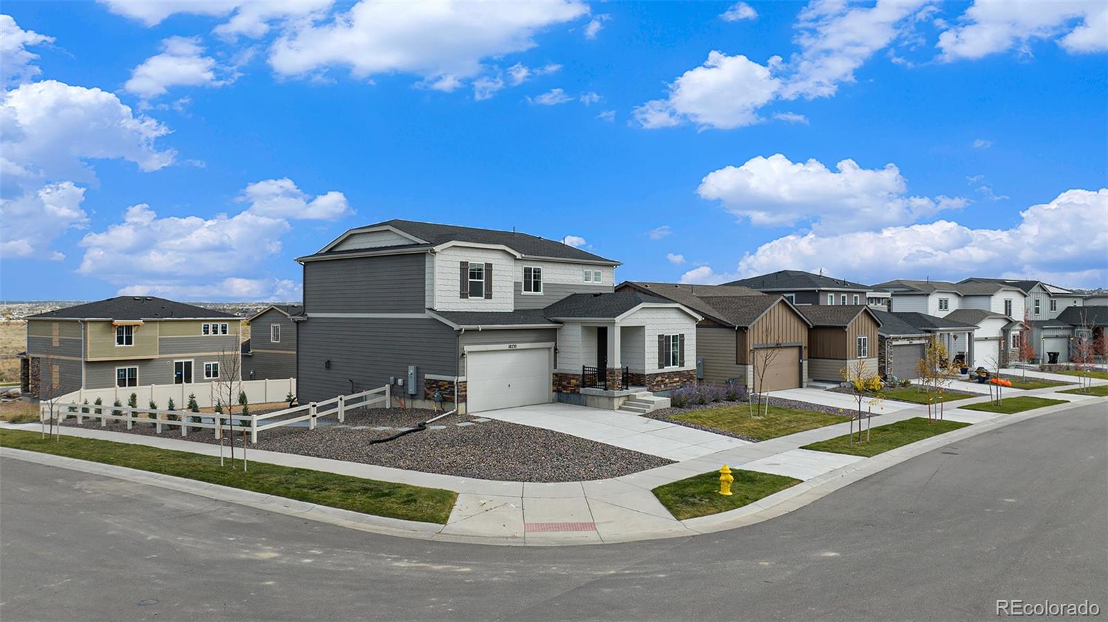 a front view of a house with yard and parking space