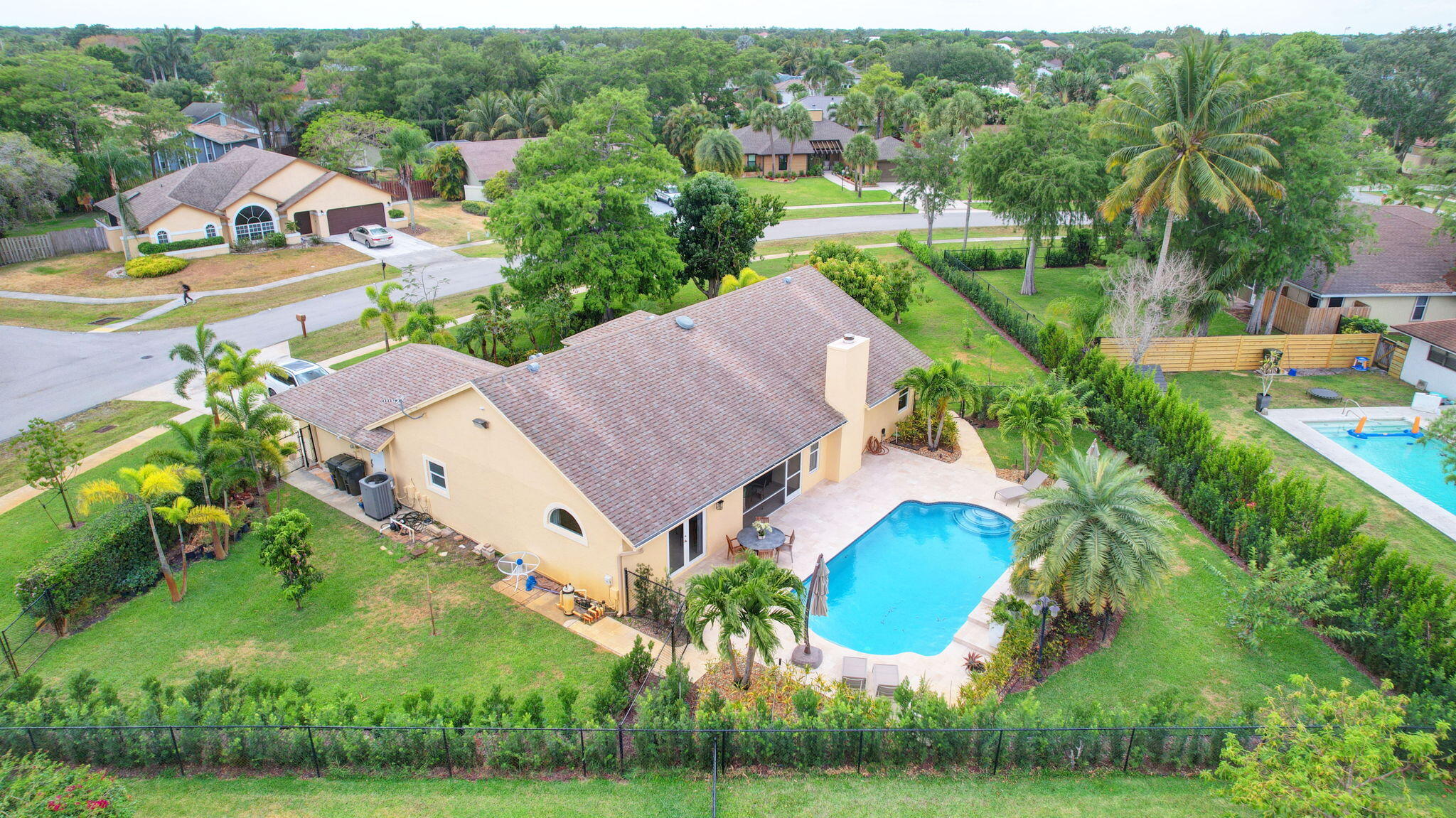 an aerial view of a house with a garden and swimming pool