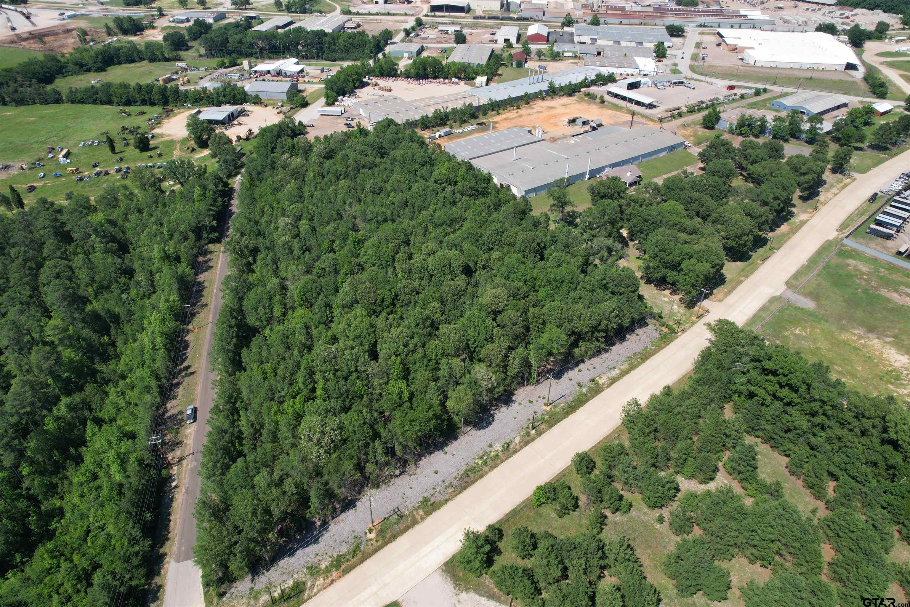 an aerial view of a house with a yard and lake view in back