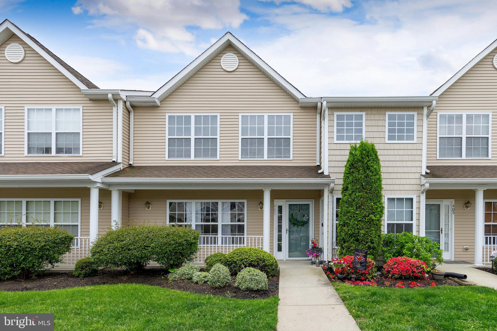 front view of a brick house with a yard