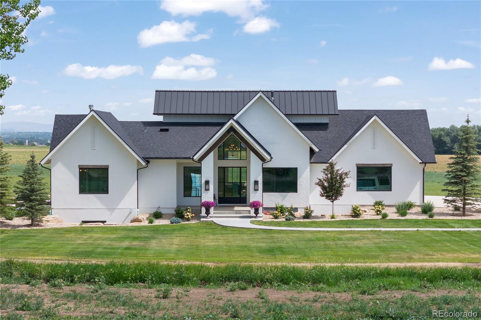 a front view of house with yard and outdoor seating