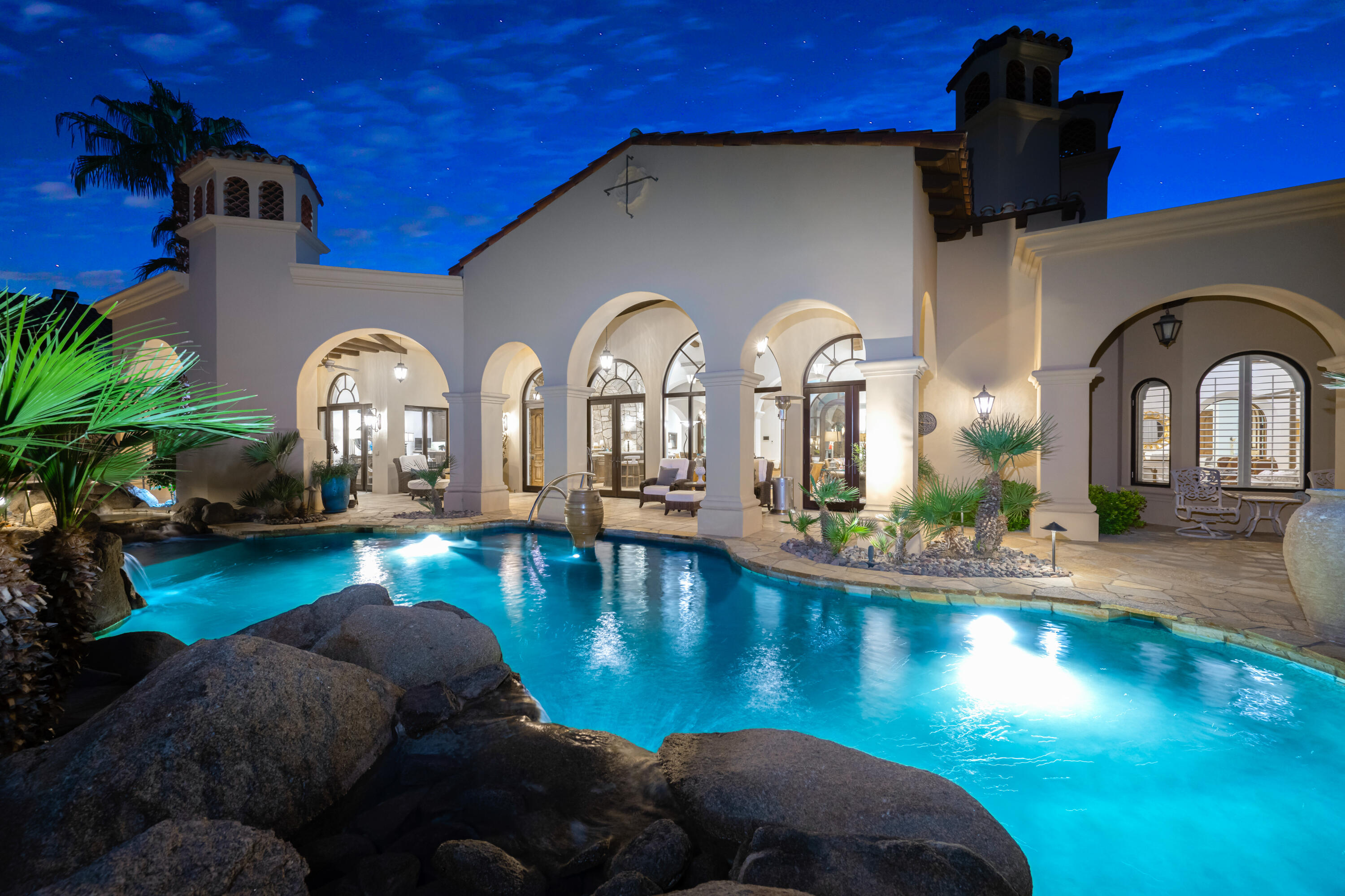 a view of a swimming pool with a dining table and chairs