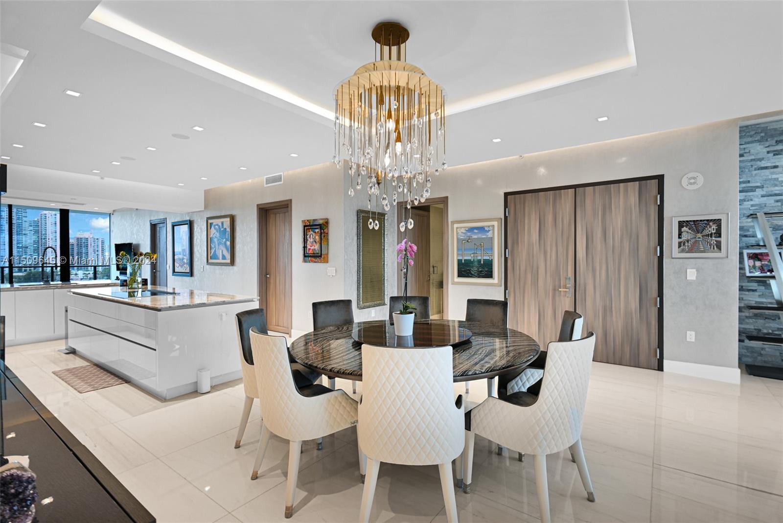 a view of a dining room with furniture and chandelier