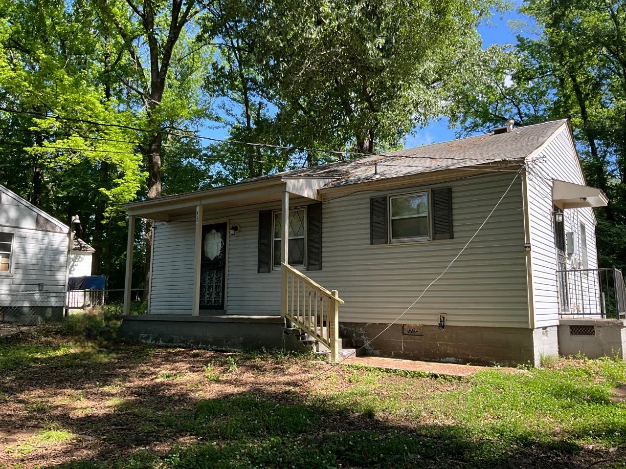 a view of house with yard