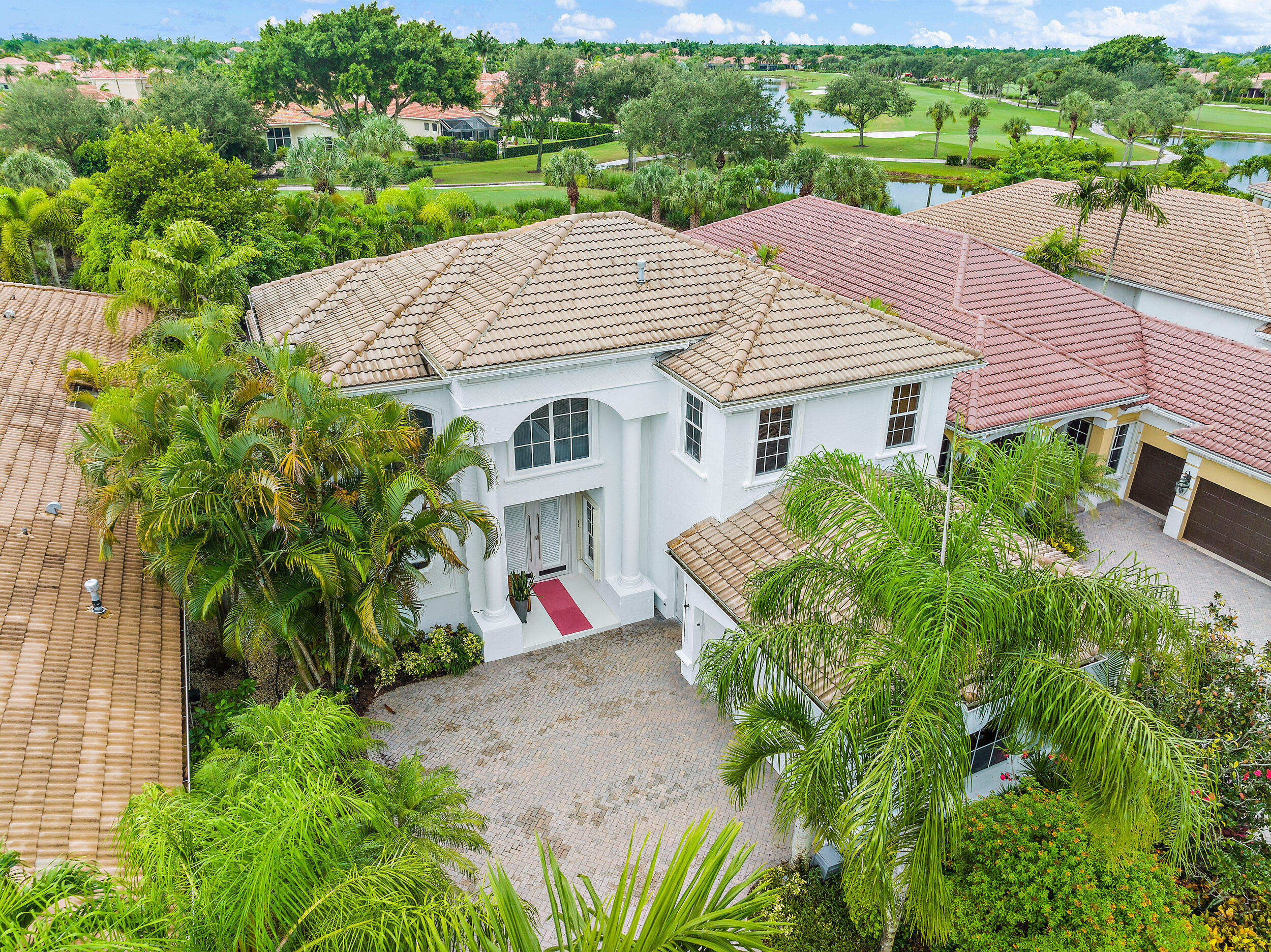 a aerial view of a house with a yard and potted plants