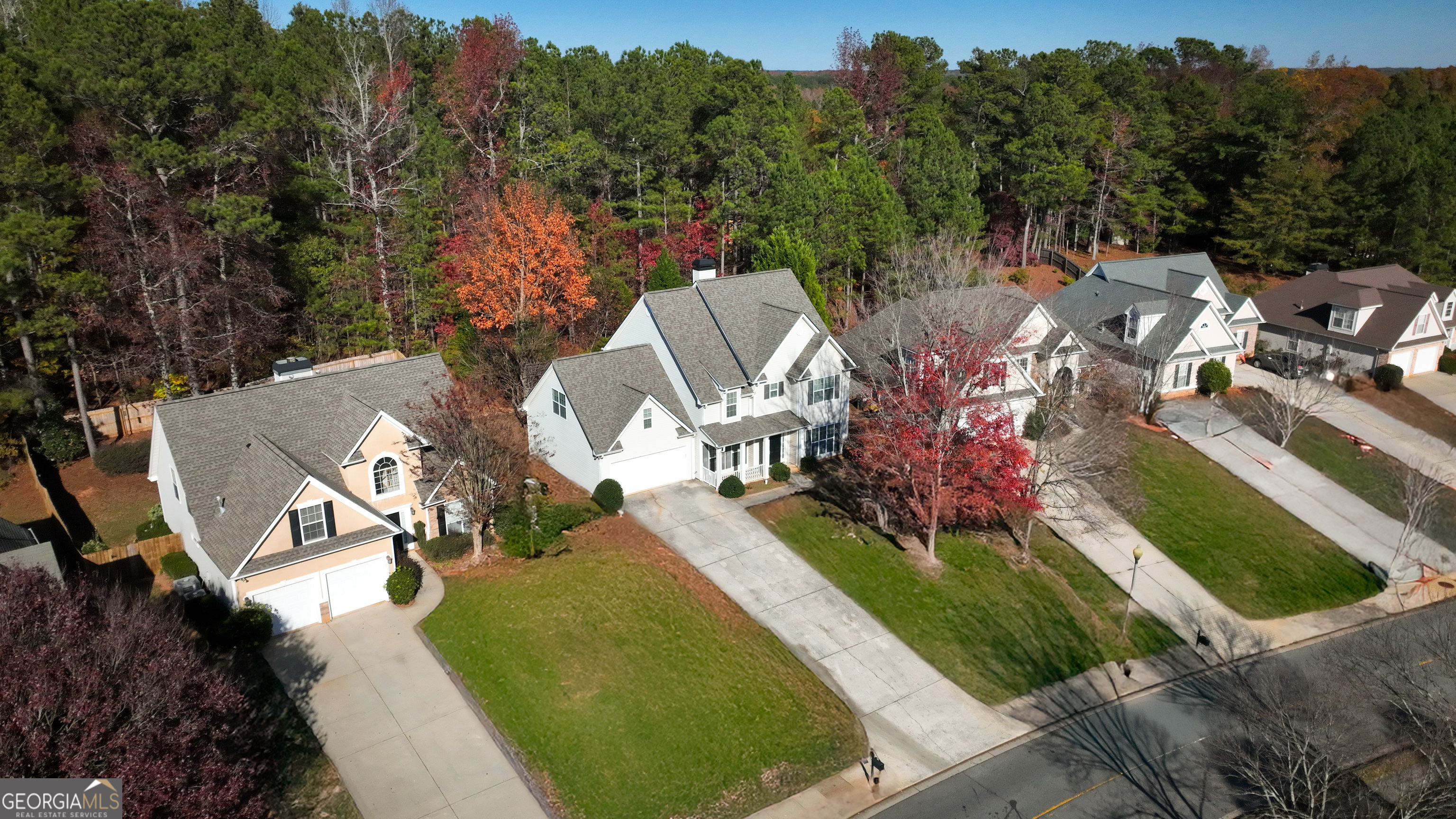 an aerial view of a house with a garden and swimming pool