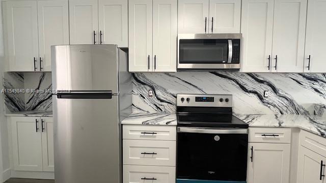 a kitchen with a stove and a refrigerator