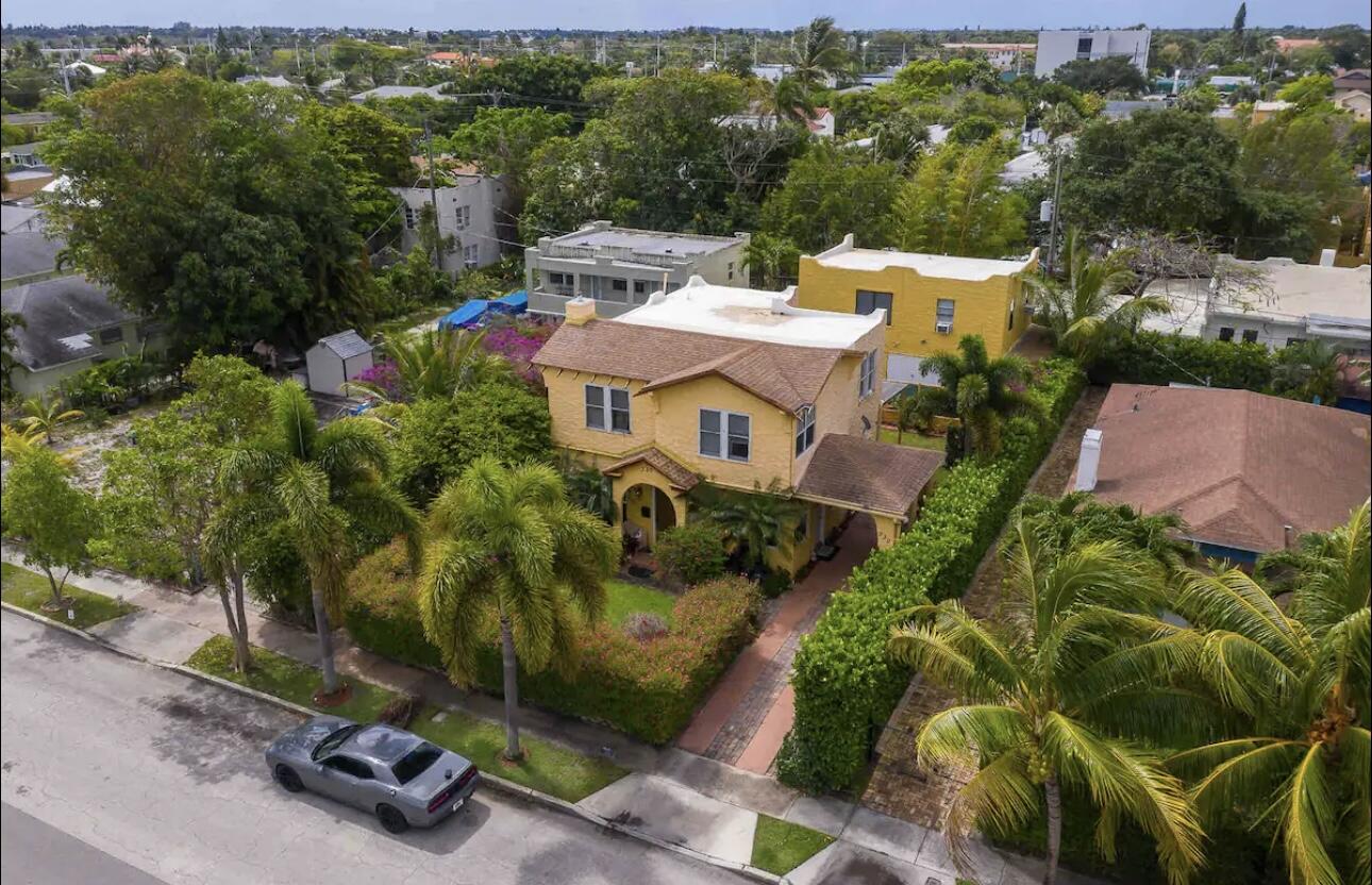 an aerial view of a house with a yard and lake view