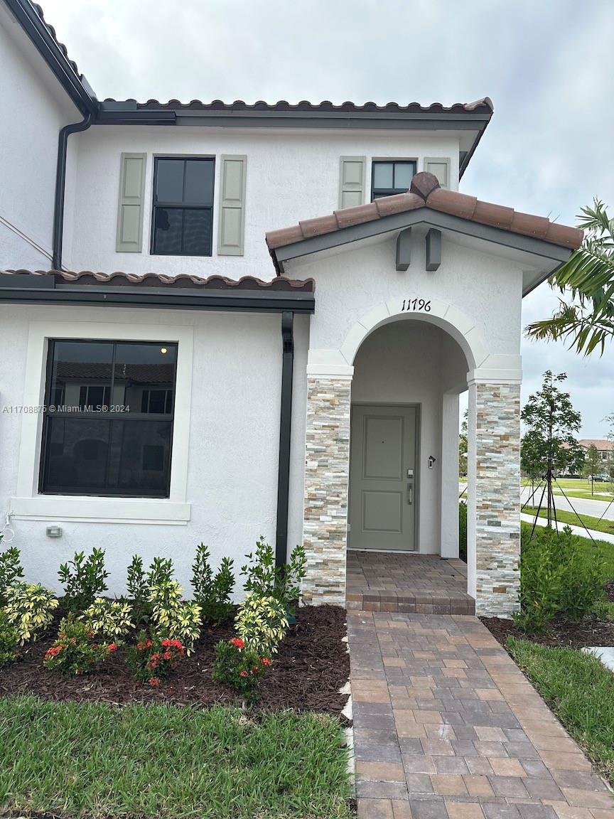 a front view of a house with garden