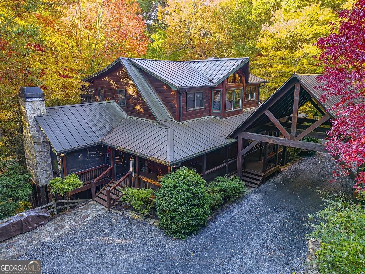 a view of a house with a yard and wooden fence