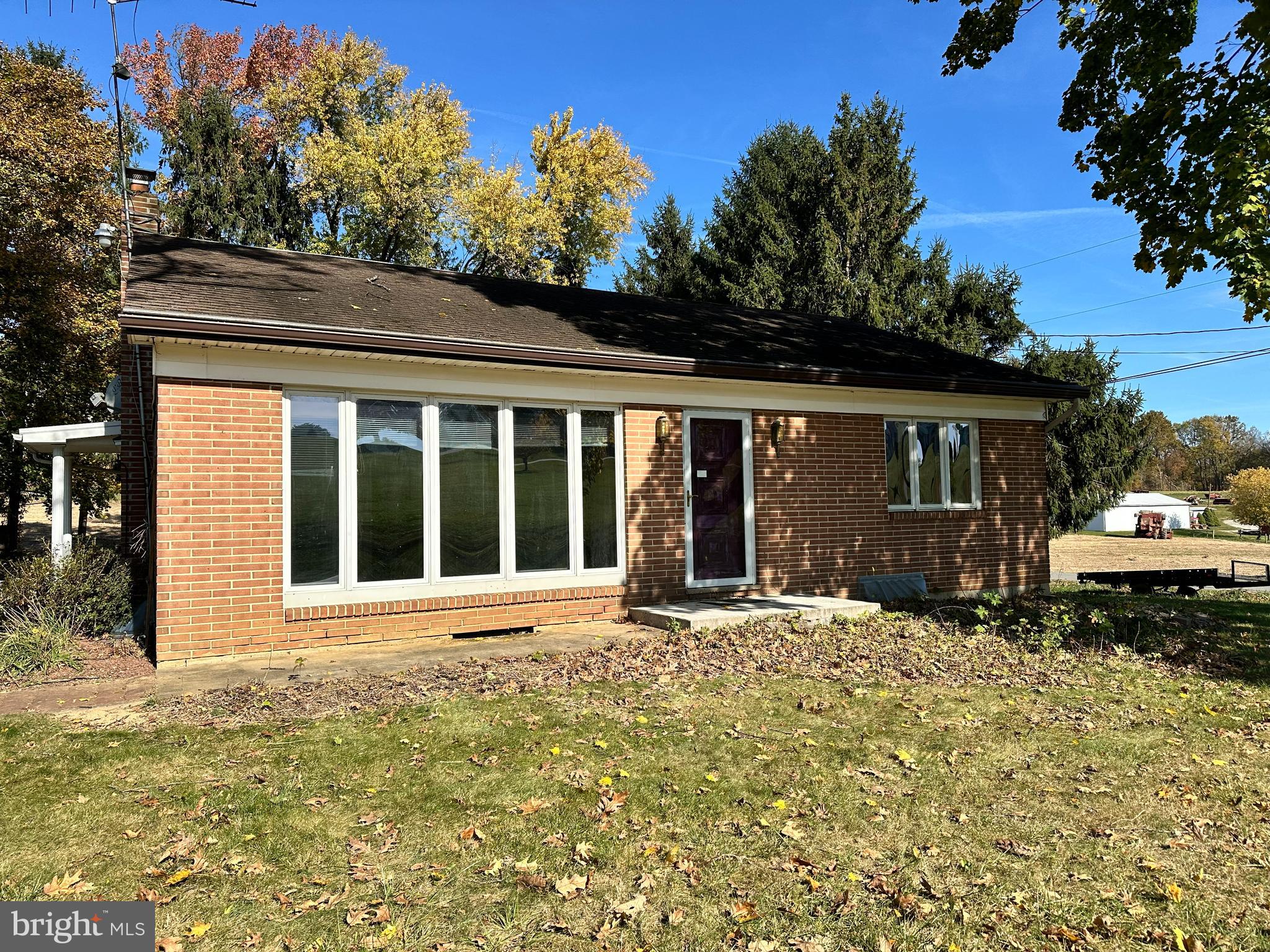 front view of a house with a large window and a yard