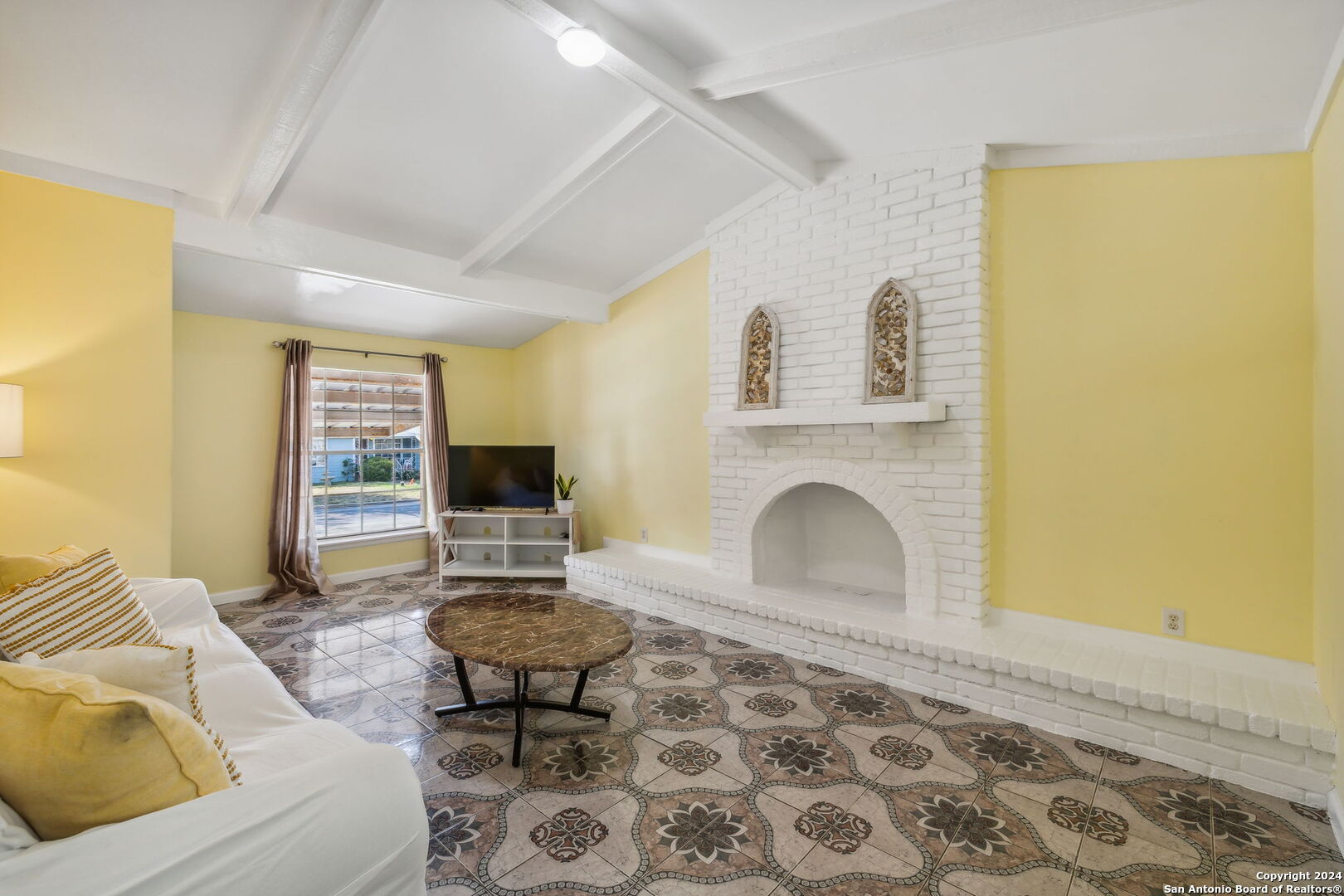 a living room with furniture and a fireplace