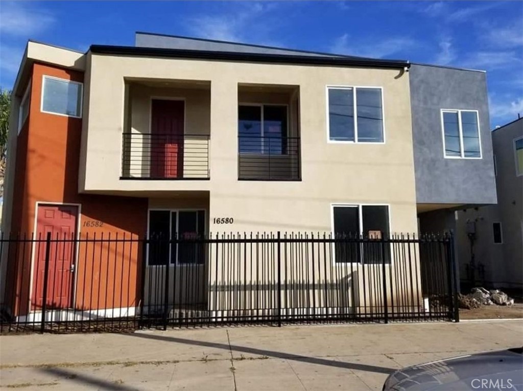 a front view of a house with a fence