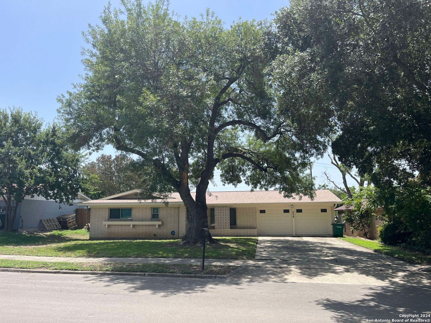 a house that has a tree in front of it