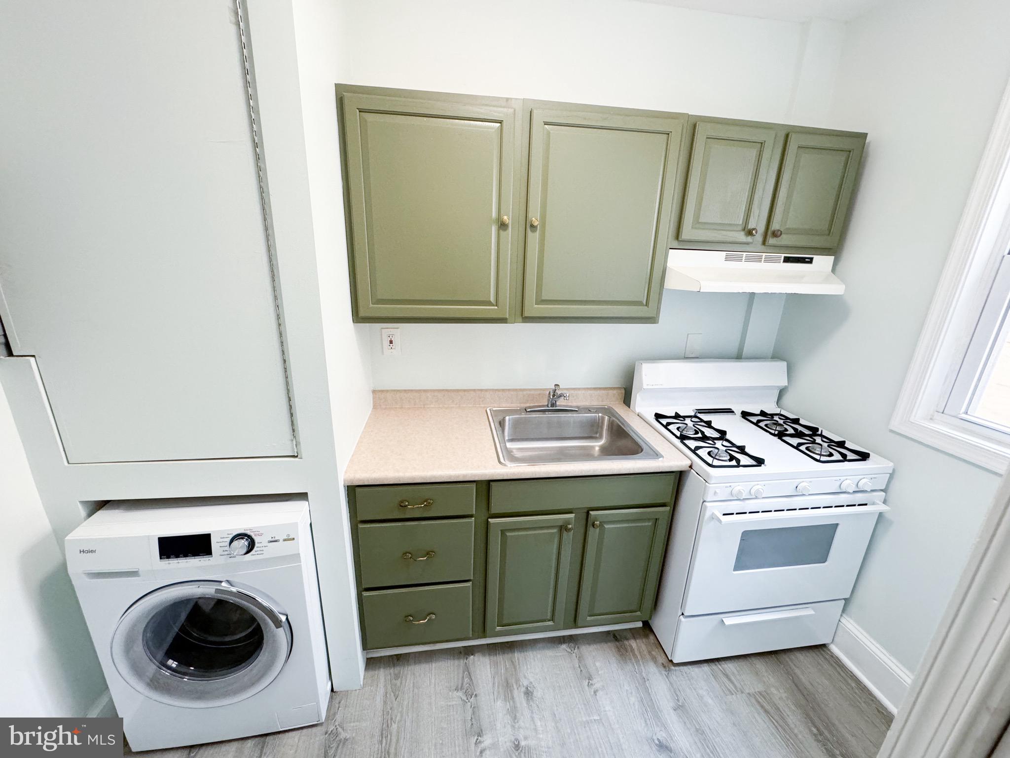 a utility room with sink dryer and washer