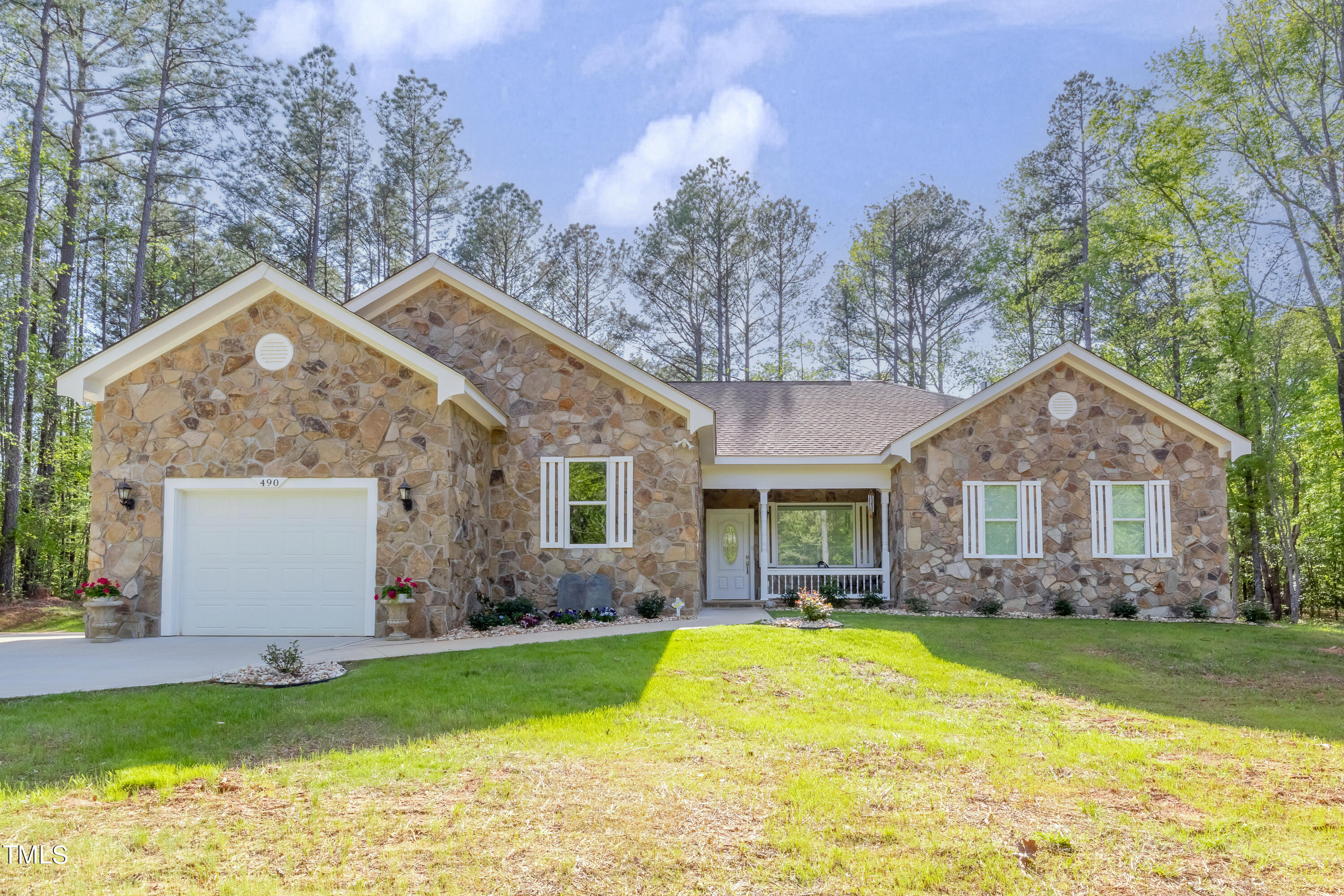 a front view of house with yard and green space