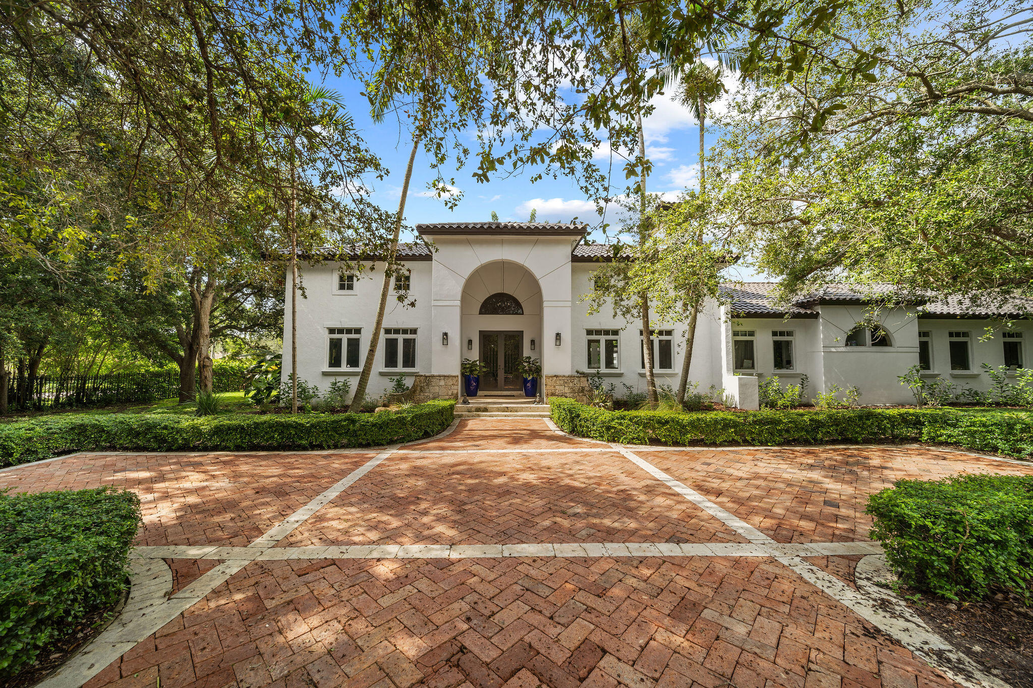 a front view of a house with a garden