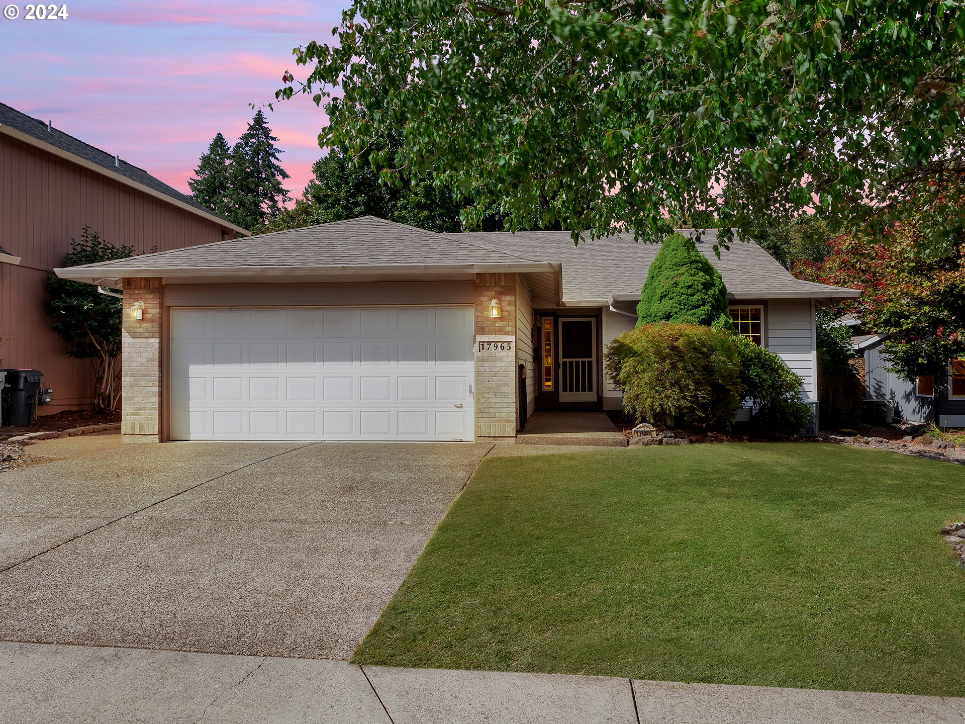 a front view of house with yard and trees