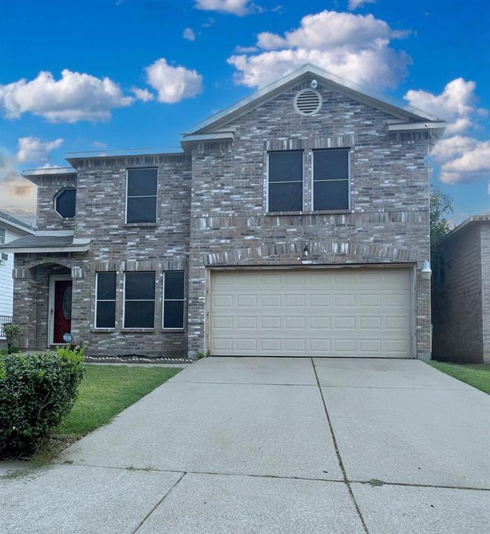 a front view of a house with garage