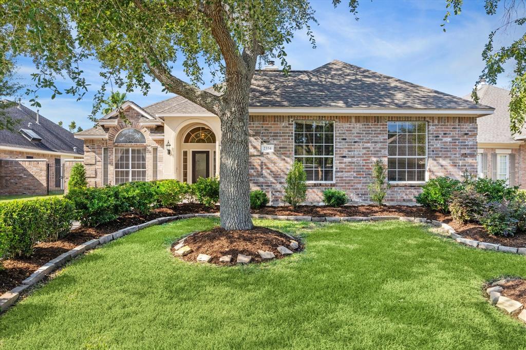 a view of a house with a backyard and a patio