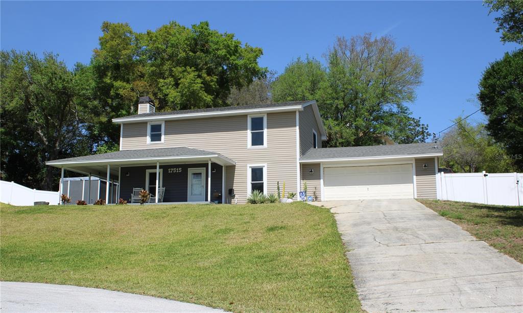 a view of a house with a yard porch and furniture