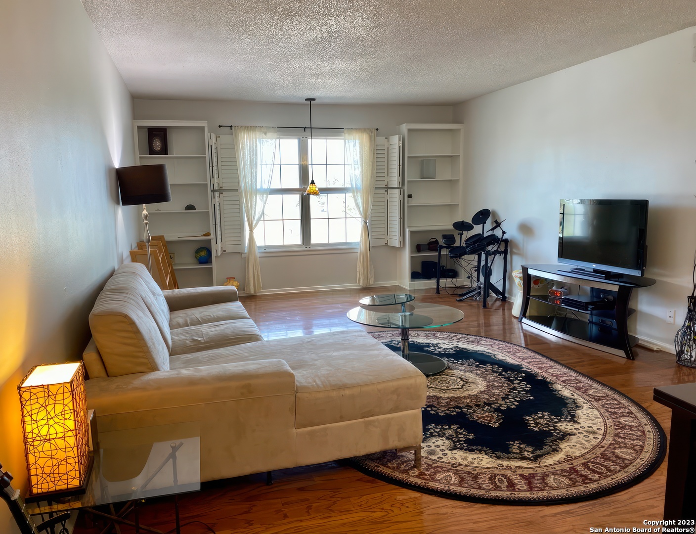 a living room with furniture and a flat screen tv