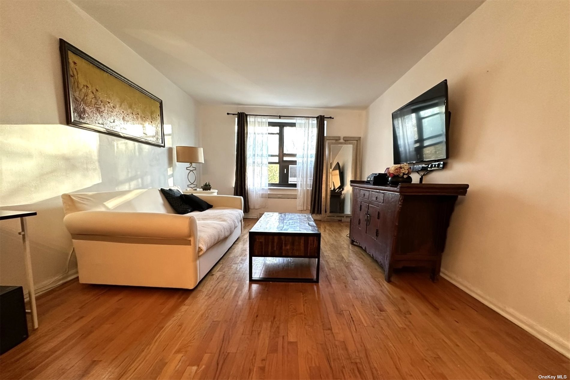 a living room with furniture and a flat screen tv