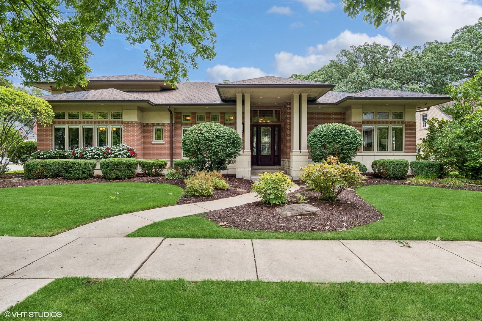 a front view of a house with a garden