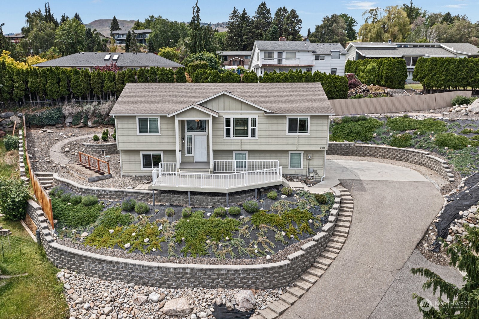 an aerial view of a house with a garden and trees