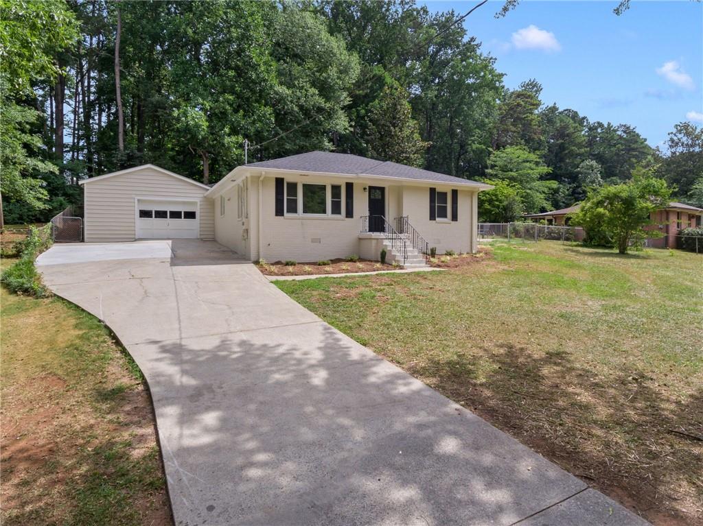 a front view of a house with a yard and trees