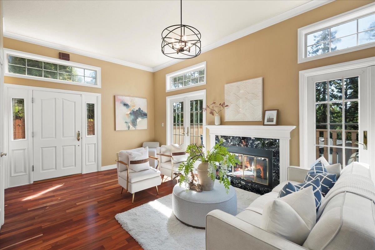 a living room with furniture fireplace and a window