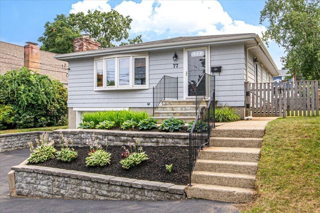 a front view of a house with a garden