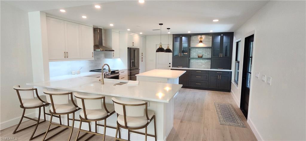 a large kitchen with a table and chairs