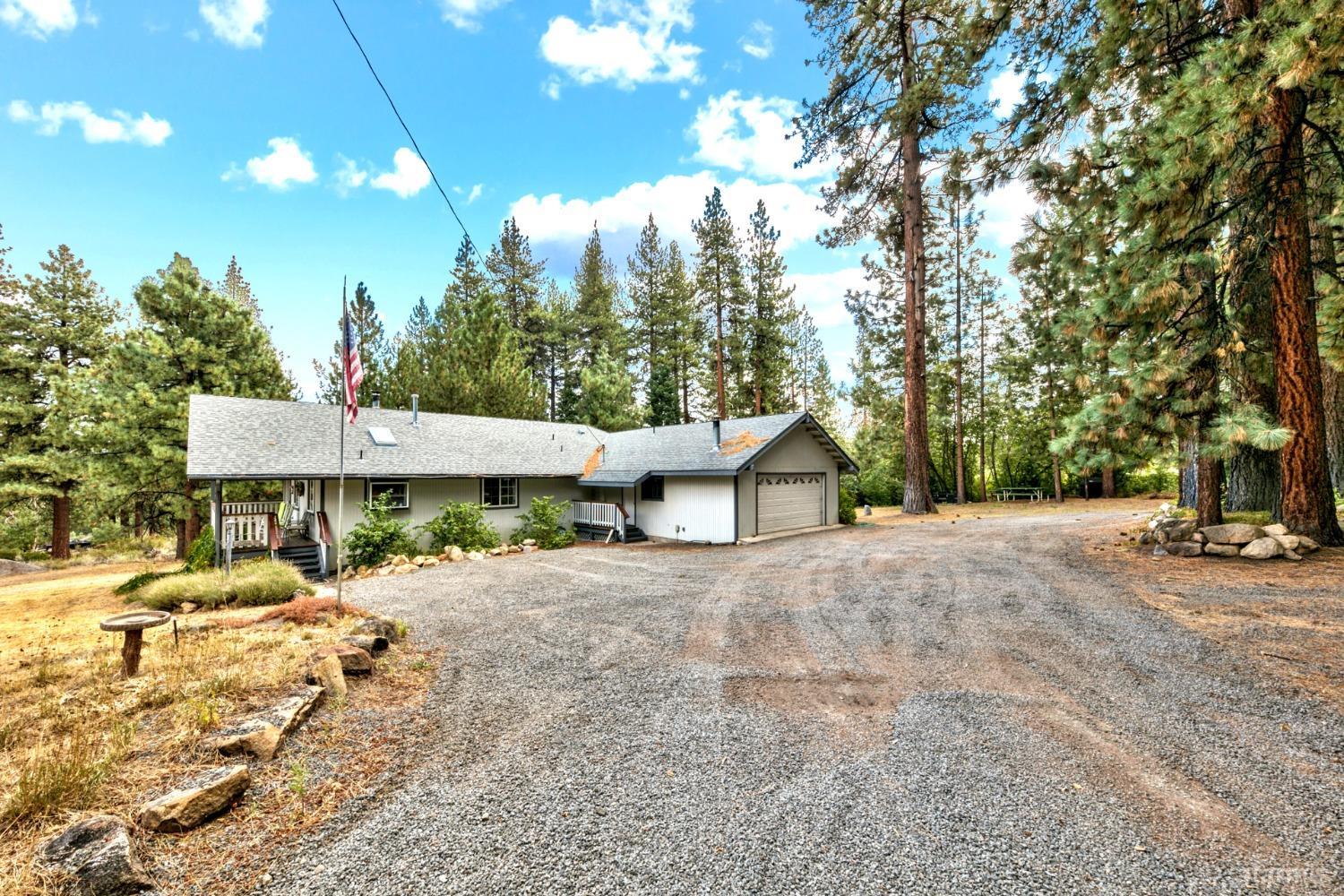 a view of a house with a yard and tree s