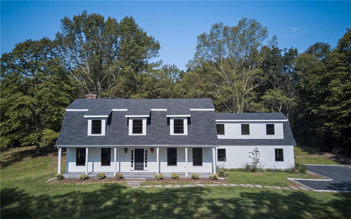 View of front of property featuring a porch and a front lawn