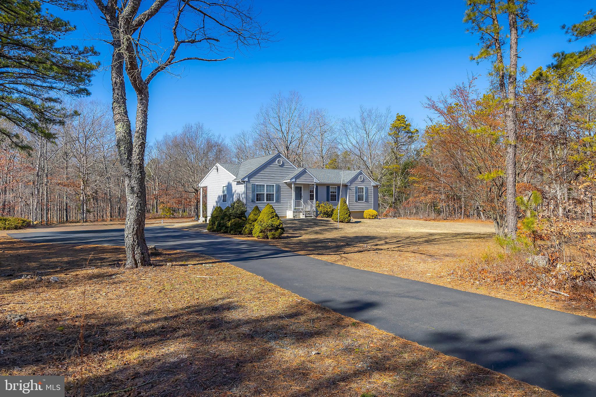 a view of an house with backyard and tree