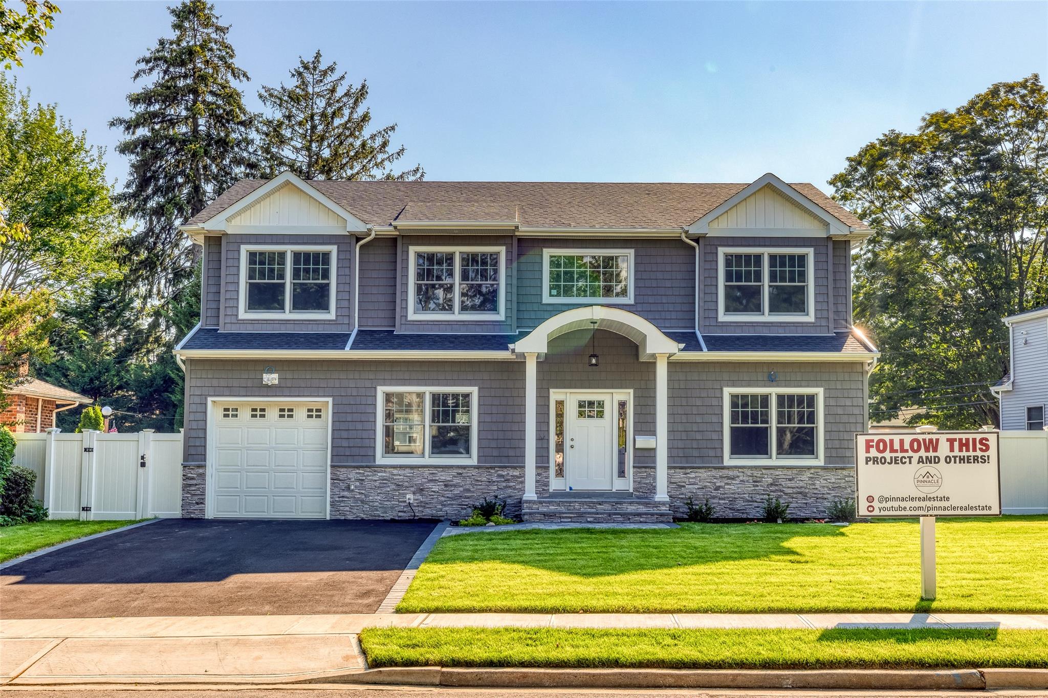 View of front of home with a front lawn and a garage