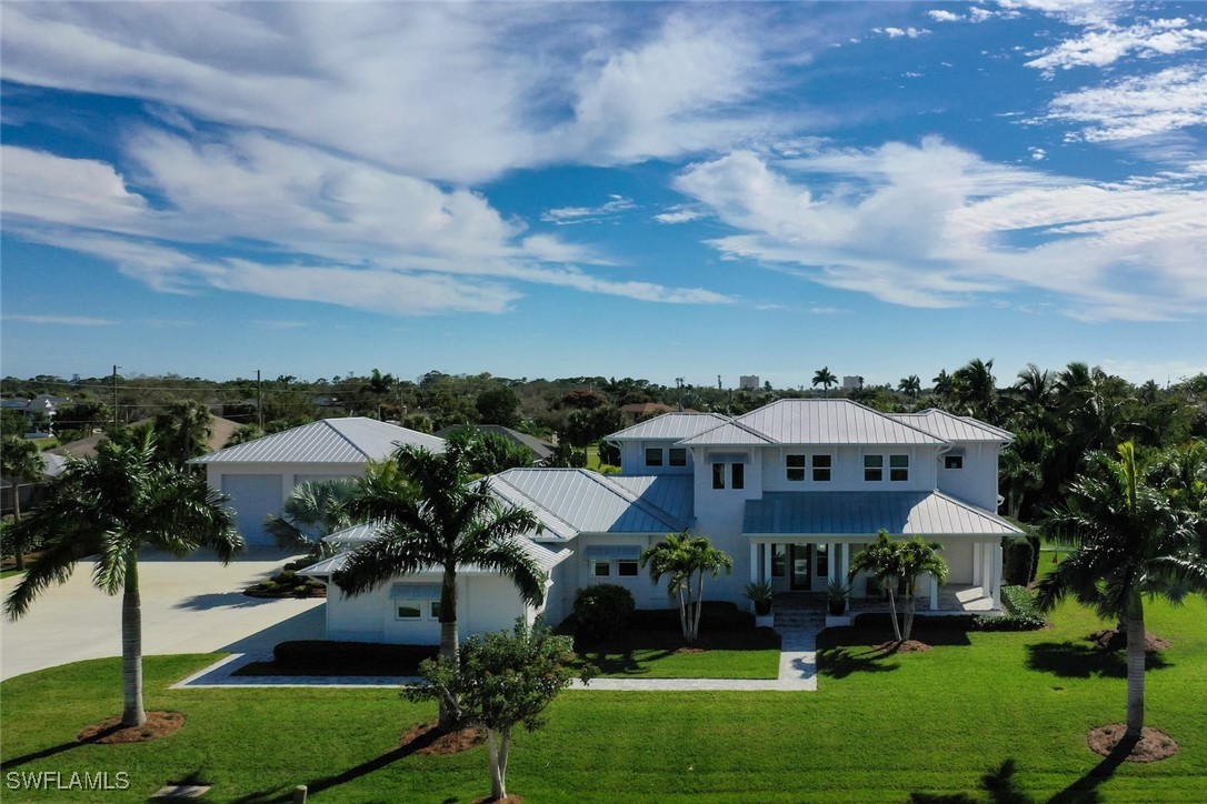 an aerial view of a house with yard and green space