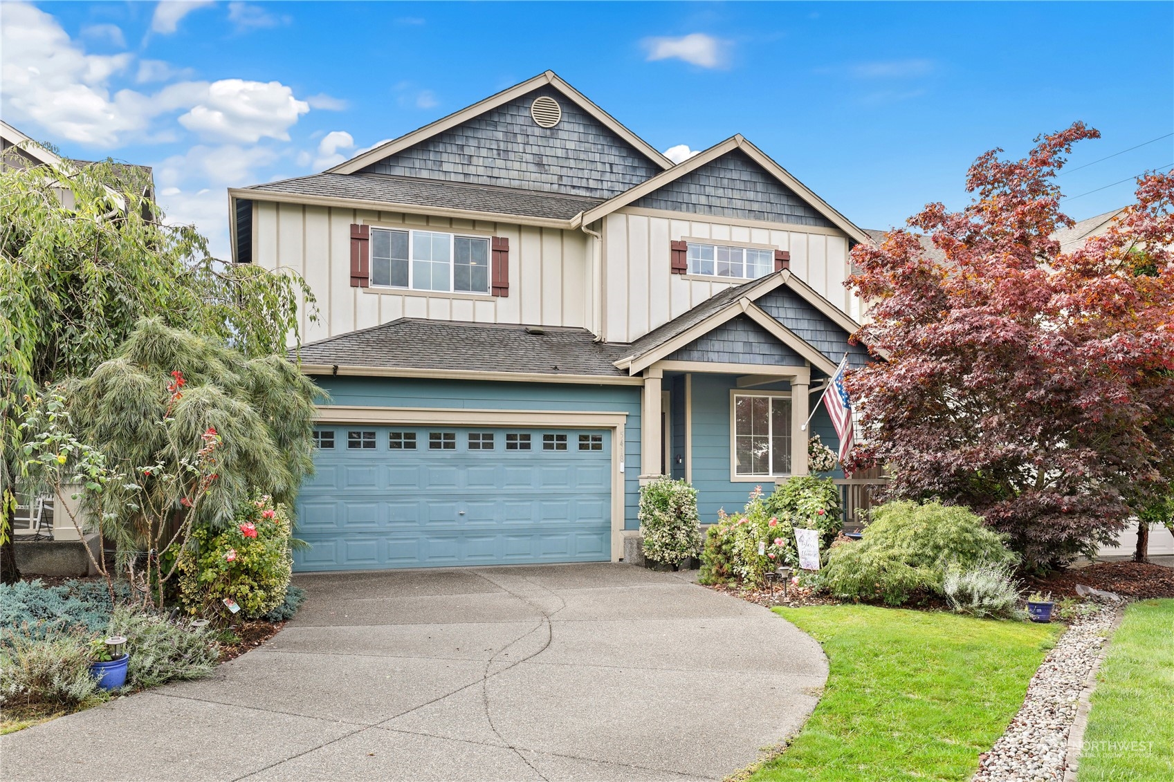 a front view of a house with a yard and garage