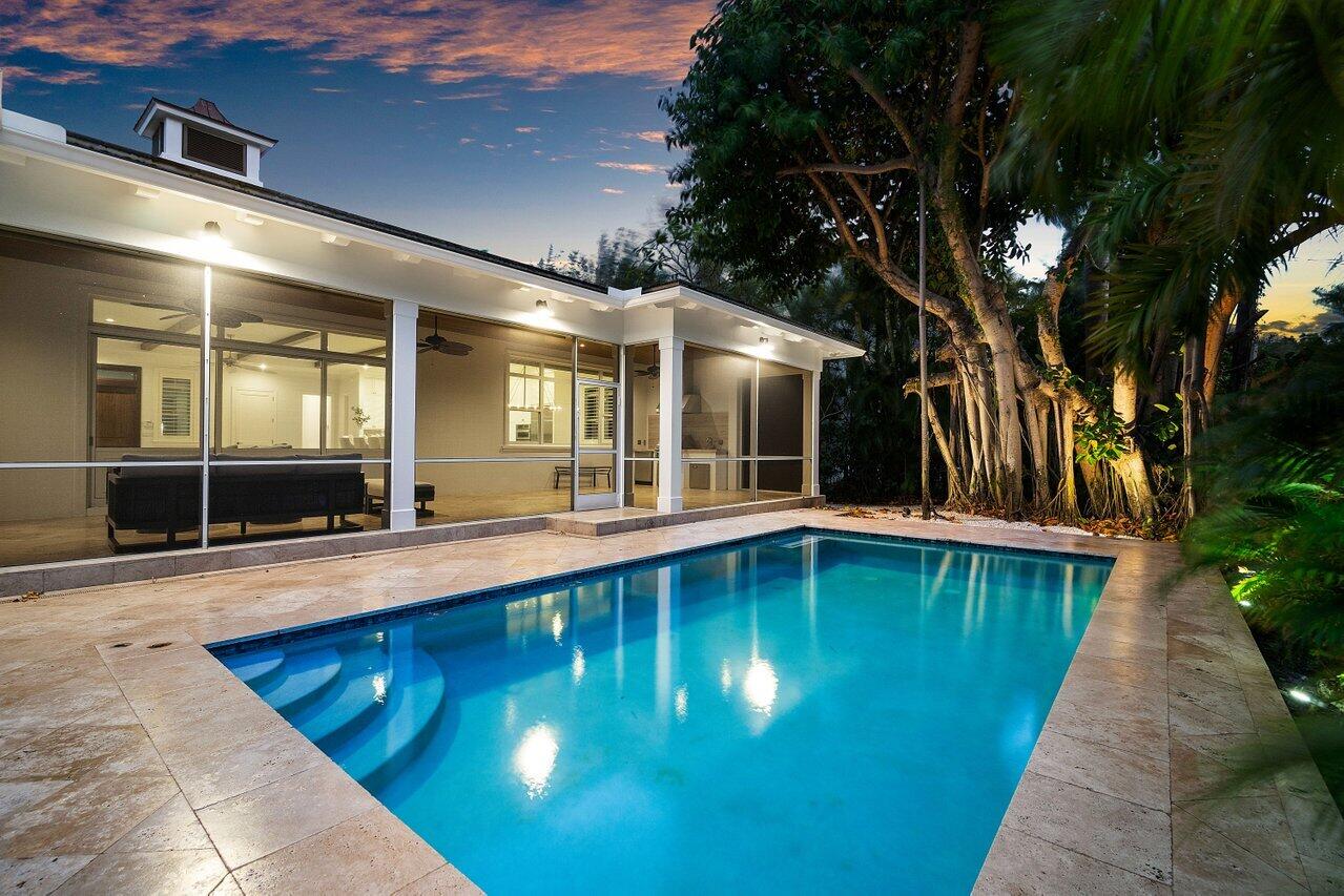 a swimming pool with patio outdoor seating and yard