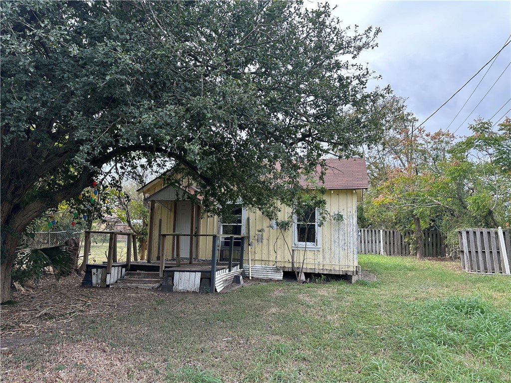 a view of a house with a yard and tree s